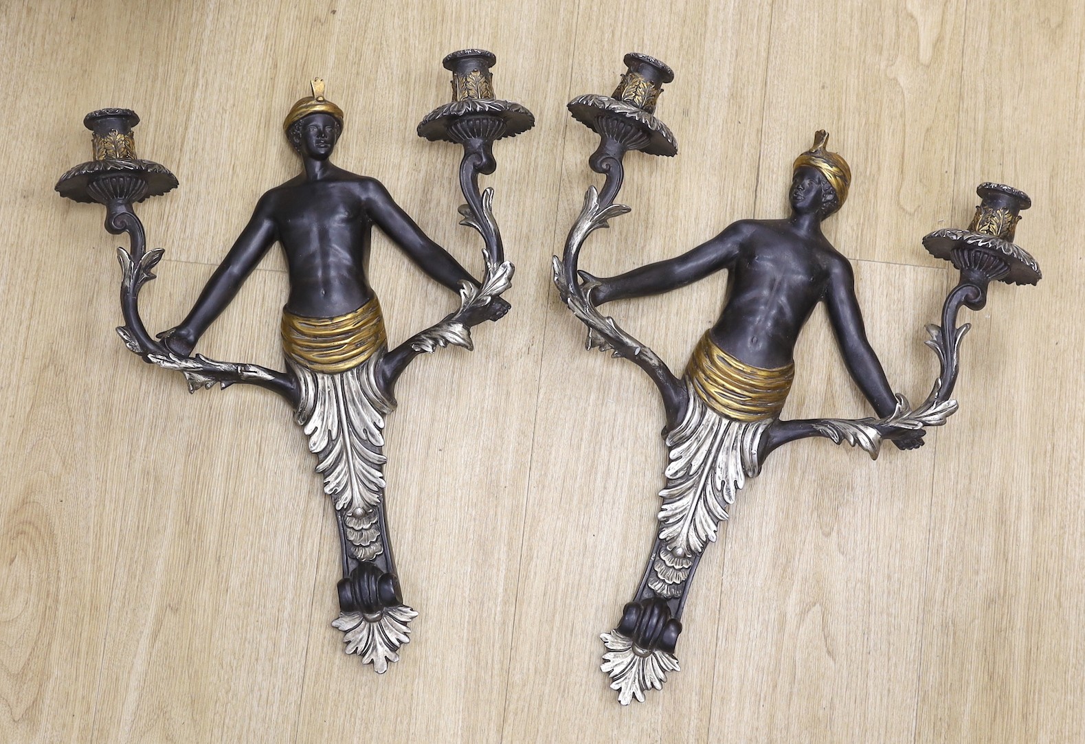 A pair of Blackamoor two branch wall lights, 53cm tall